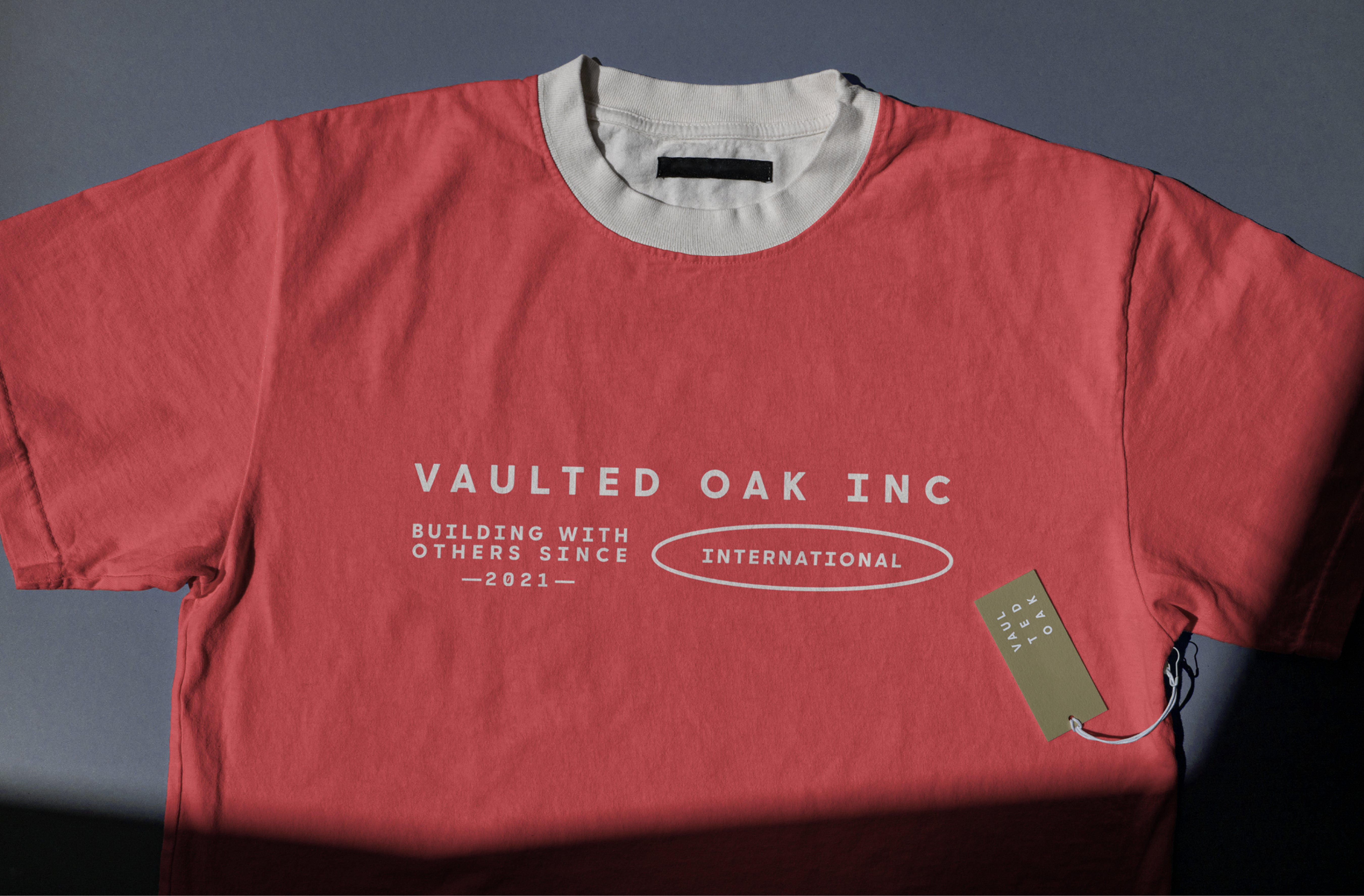 Red t-shirt with 'Vaulted Oak Inc' text on a dark background